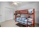 Bedroom showcasing a bunk bed with a double closet and tropical plant at 212 Millwood Dr., Surfside Beach, SC 29575