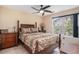 Bedroom with four poster bed, ceiling fan, and natural light from a large window at 212 Millwood Dr., Surfside Beach, SC 29575