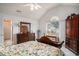 Bright bedroom with floral bedding, vaulted ceiling, and view of ensuite bathroom at 212 Millwood Dr., Surfside Beach, SC 29575