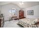 Bright bedroom features a floral bedspread, vintage furniture, and a window view at 212 Millwood Dr., Surfside Beach, SC 29575