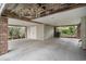 Spacious carport with brick supports, textured floor, and a convenient storage room at 212 Millwood Dr., Surfside Beach, SC 29575