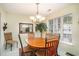 Comfortable dining area with round table, wooden chairs, and natural lighting by a window at 212 Millwood Dr., Surfside Beach, SC 29575