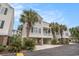 Raised beach home showing multiple units, neutral siding, and mature palm trees throughout the neighborhood at 212 Millwood Dr., Surfside Beach, SC 29575
