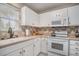 Bright kitchen with ample counter space, white appliances, and tiled backsplash at 212 Millwood Dr., Surfside Beach, SC 29575