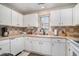 Kitchen boasts white cabinets, neutral countertops, and tiled backsplash at 212 Millwood Dr., Surfside Beach, SC 29575