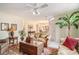 Open-concept living room with neutral walls, tropical foliage, and seamless flow to the dining area at 212 Millwood Dr., Surfside Beach, SC 29575