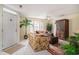 Inviting living room with tropical decor, white tile flooring, and an abundance of natural light at 212 Millwood Dr., Surfside Beach, SC 29575