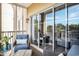 Screened-in balcony with seating area, offering scenic outdoor views through sliding glass doors at 2180 Waterview Dr. # 725, North Myrtle Beach, SC 29582