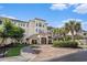 Exterior of a beautiful building with a brick entrance, palm trees, and well-kept landscaping at 2180 Waterview Dr. # 725, North Myrtle Beach, SC 29582