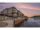 Exterior of a building with balconies overlooking a waterway with a bulkhead, fence and landscaping at 2180 Waterview Dr. # 725, North Myrtle Beach, SC 29582