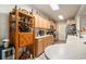 Well-lit kitchen with wooden cabinets, modern appliances, and shelving, providing ample storage and functionality at 2180 Waterview Dr. # 725, North Myrtle Beach, SC 29582