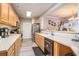 Well-lit kitchen with wood cabinets, stainless steel appliances, and open view to the dining area at 2180 Waterview Dr. # 725, North Myrtle Beach, SC 29582