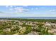 A scenic aerial view of a vibrant coastal community with tree-lined streets and blue ocean backdrop at 219 Caropine Dr., Surfside Beach, SC 29575