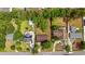 An aerial view shows the layout of three homes and their surrounding landscaping and neighborhood streets at 219 Caropine Dr., Surfside Beach, SC 29575
