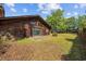 Spacious backyard features a patio, lush lawn, mature trees, providing a private outdoor retreat perfect for relaxation at 219 Caropine Dr., Surfside Beach, SC 29575