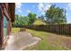 Large backyard with patio, mature trees, and lawn offers ample space for outdoor activities and relaxation at 219 Caropine Dr., Surfside Beach, SC 29575