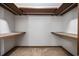 Walk-in closet featuring carpet flooring, wire hanging bar, and wooden shelving, ready for customized storage solutions at 219 Caropine Dr., Surfside Beach, SC 29575