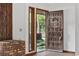 Inviting entryway featuring a dark wood door, tile flooring and access to the front yard at 219 Caropine Dr., Surfside Beach, SC 29575