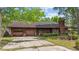 Charming single-story brick home featuring an attached garage and mature tree. Some TLC is needed at 219 Caropine Dr., Surfside Beach, SC 29575