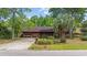 Charming single-story brick home featuring an attached garage, mature tree, and inviting curb appeal at 219 Caropine Dr., Surfside Beach, SC 29575