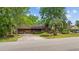 Charming single-story brick home featuring an attached garage, mature tree, and inviting curb appeal at 219 Caropine Dr., Surfside Beach, SC 29575