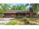 Charming single-story brick home featuring an attached garage and well-maintained landscaping at 219 Caropine Dr., Surfside Beach, SC 29575