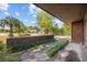 Charming front yard view showcasing low brick walls with manicured grasses and a home in the background on a sunny day at 219 Caropine Dr., Surfside Beach, SC 29575