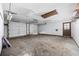 Spacious garage with two car doors, concrete floors, and overhead lighting offers ample parking and workspace potential at 219 Caropine Dr., Surfside Beach, SC 29575