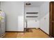 Functional utility room with water heater, shelving and damaged flooring, ready for improvements or storage space at 219 Caropine Dr., Surfside Beach, SC 29575
