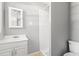 Cozy bathroom featuring a vanity with sink, toilet, shower, and mirror with a cabinet at 2415 Magnolia Lane, Little River, SC 29566