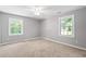 Spacious bedroom with carpeting, neutral walls, ceiling fan and dual windows at 2415 Magnolia Lane, Little River, SC 29566