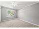 Well-lit bedroom with neutral carpet, a window for natural light, and plenty of space at 2415 Magnolia Lane, Little River, SC 29566