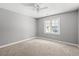 Bright bedroom featuring neutral walls, carpet, ceiling fan, and natural light from a window at 2415 Magnolia Lane, Little River, SC 29566