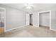 Bright bedroom with hardwood floor in the doorway, neutral carpet and walls, and spacious closet at 2415 Magnolia Lane, Little River, SC 29566