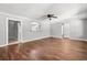 Living room featuring hardwood floors, neutral walls, ceiling fan, and an archway leading to the kitchen at 2415 Magnolia Lane, Little River, SC 29566
