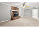 Inviting living room showcasing a brick fireplace, neutral carpet, and a ceiling fan at 2415 Magnolia Lane, Little River, SC 29566