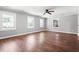 Sun-drenched living room featuring hardwood floors, neutral paint, and several windows for abundant natural light at 2415 Magnolia Lane, Little River, SC 29566