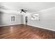 Bright living room featuring hardwood floors, neutral paint, ceiling fan, and an archway to the kitchen at 2415 Magnolia Lane, Little River, SC 29566