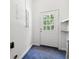 Functional mud room featuring a utility sink, storage shelves and a back door leading outdoors at 2415 Magnolia Lane, Little River, SC 29566
