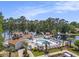 Aerial view of the community pool and lake, nestled among mature trees and landscaping at 2479 Glen Dr., Little River, SC 29566
