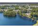 Aerial view of a lakeside community featuring lush trees, a bridge, and a sparkling pool at 2479 Glen Dr., Little River, SC 29566