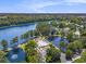 A stunning aerial view of the community pool, lake, and surrounding lush greenery at 2479 Glen Dr., Little River, SC 29566