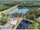 Aerial view showcases the pool, nearby highway, beautiful lake, and mature trees at 2479 Glen Dr., Little River, SC 29566