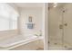 Bathroom featuring soaking tub next to large glass enclosed shower at 2479 Glen Dr., Little River, SC 29566