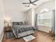 Bedroom with hardwood floors, ceiling fan, and abundant natural light at 2479 Glen Dr., Little River, SC 29566