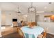 Open dining area with wood floors, chandelier, and a seamless flow to the kitchen and living spaces at 2479 Glen Dr., Little River, SC 29566