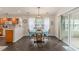 Cozy dining area with backyard access, wooden table and chairs, and an adjacent kitchen at 2479 Glen Dr., Little River, SC 29566