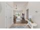 Inviting home foyer with neutral walls, tiled flooring, and a view into the light-filled living area at 2479 Glen Dr., Little River, SC 29566
