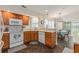 Well-lit kitchen featuring modern appliances, warm wood cabinetry, and a breakfast bar overlooking the dining area at 2479 Glen Dr., Little River, SC 29566