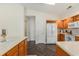 Bright kitchen features wood cabinets, white appliances, and a decorative tile floor at 2479 Glen Dr., Little River, SC 29566